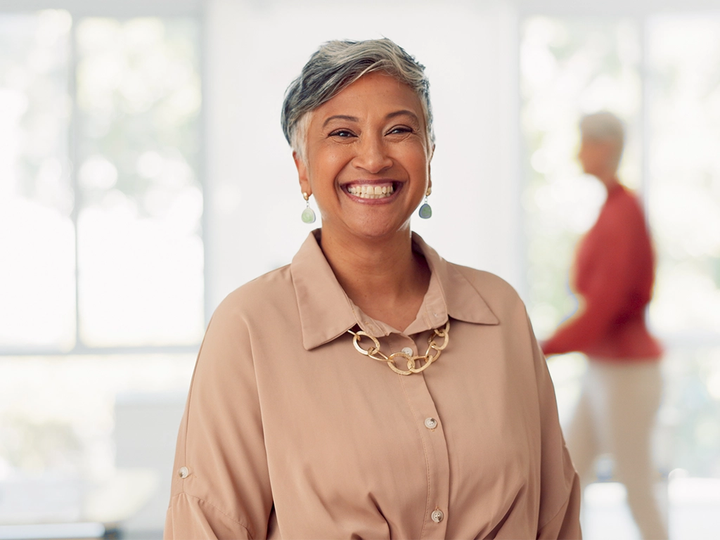 Senior business woman, leadership and smile for management, vision or success at the office