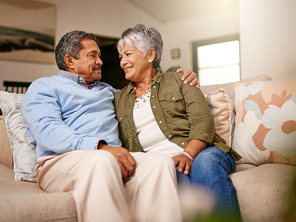happy older couple relaxing on the sofa together at home.